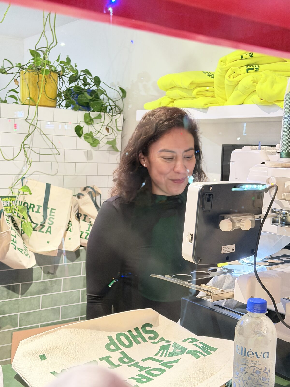 Guests customizing canvas tote bags at a live printing station