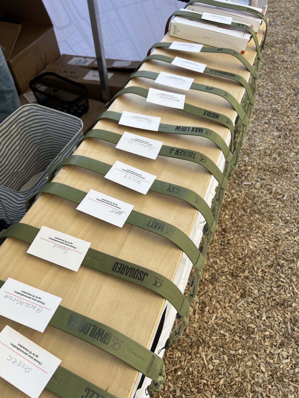 Close-up of rolled printed apparel bundles wrapped in kraft paper with labels, stacked in rows